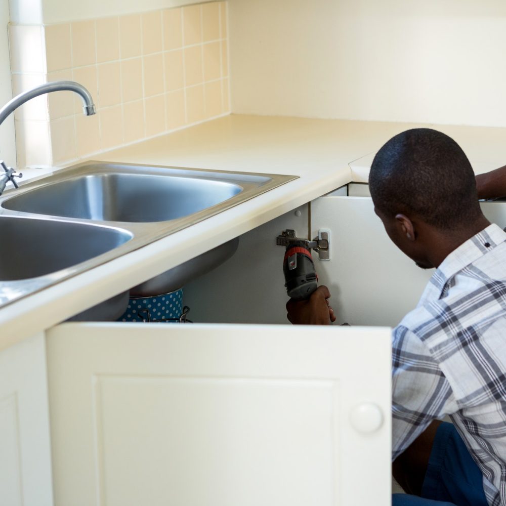 Man repairing a kitchen sink